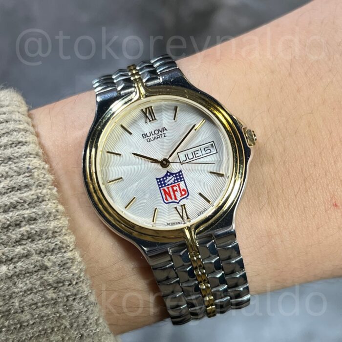 JAM TANGAN VINTAGE BULOVA x NFL ROUND TWO TONE SILVER SUNBURST DIAL DAY-DATE WITH SPANISH DATE (LX2022)